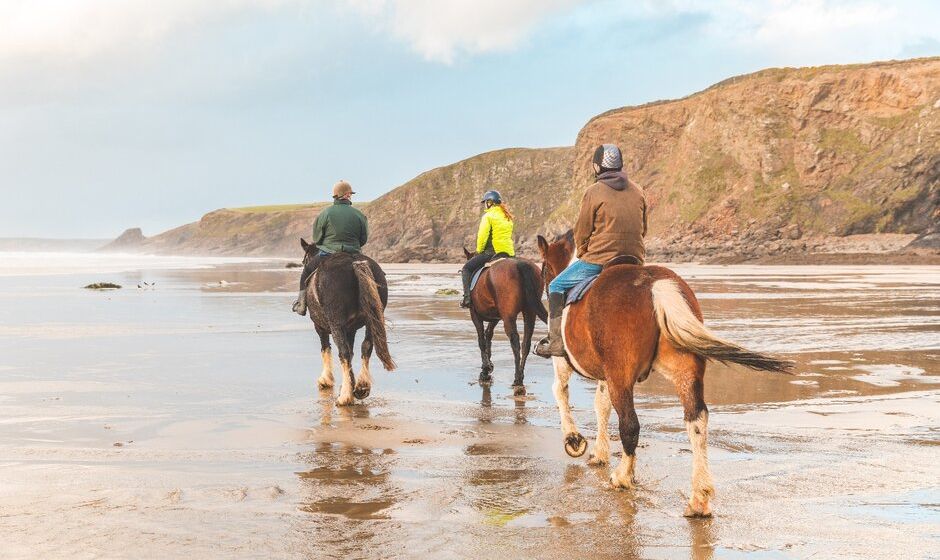 Horse riders on a beach